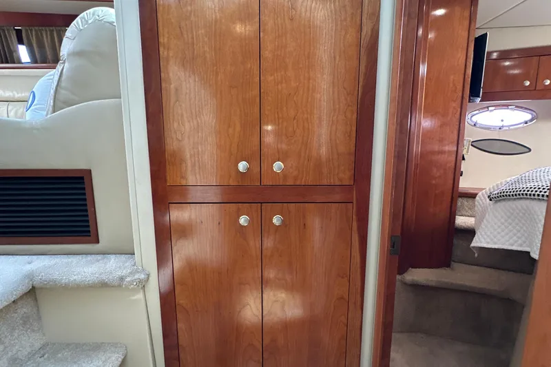 Knot Available Yacht Photos Pics Interior of 2004 Cruisers Yachts 405 Express Motoryacht with wooden cabinetry and cozy cabin.