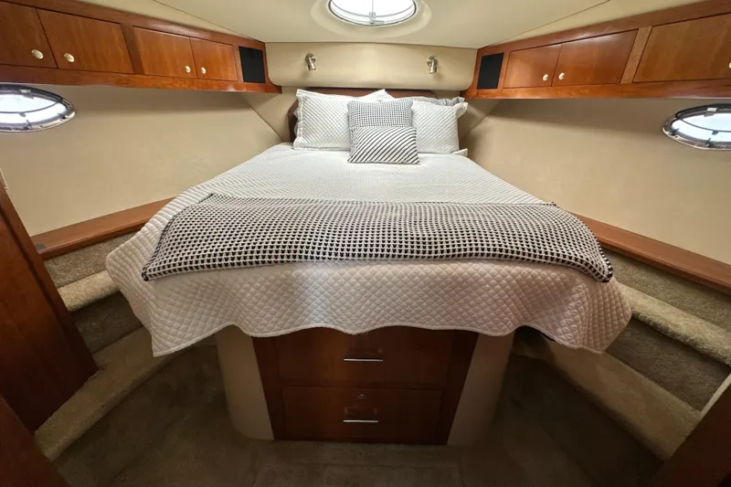 Knot Available Yacht Photos Pics Luxurious bedroom in 2004 Cruisers Yachts 405 Express Motoryacht with elegant bedding and wood cabinetry.