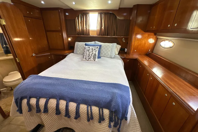 Knot Available Yacht Photos Pics Luxurious 2004 Cruisers Yachts 405 Express Motoryacht bedroom with elegant wood cabinetry.