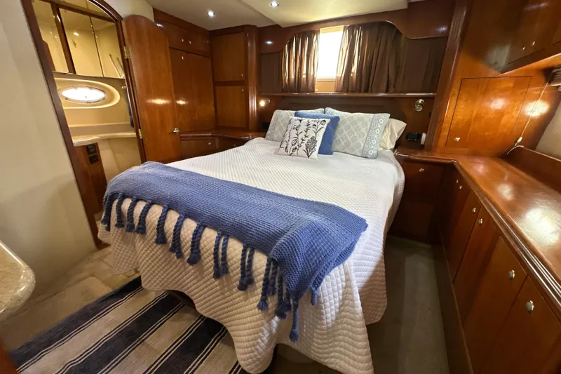 Knot Available Yacht Photos Pics Luxurious bedroom in 2004 Cruisers Yachts 405 Express Motoryacht with elegant wood cabinetry.