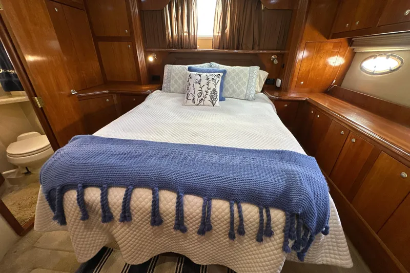 Knot Available Yacht Photos Pics Luxurious 2004 Cruisers Yachts 405 Express Motoryacht bedroom with elegant wood cabinetry.