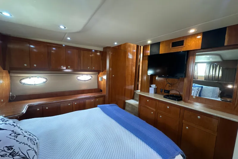 Knot Available Yacht Photos Pics Luxurious 2004 Cruisers Yachts 405 Express Motoryacht bedroom with wood cabinetry and modern amenities.