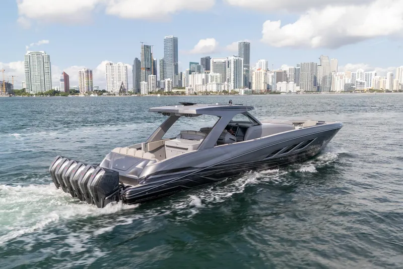  Yacht Photos Pics Luxury 2026 Deep Impact 499 Sport boat cruising near city skyline.