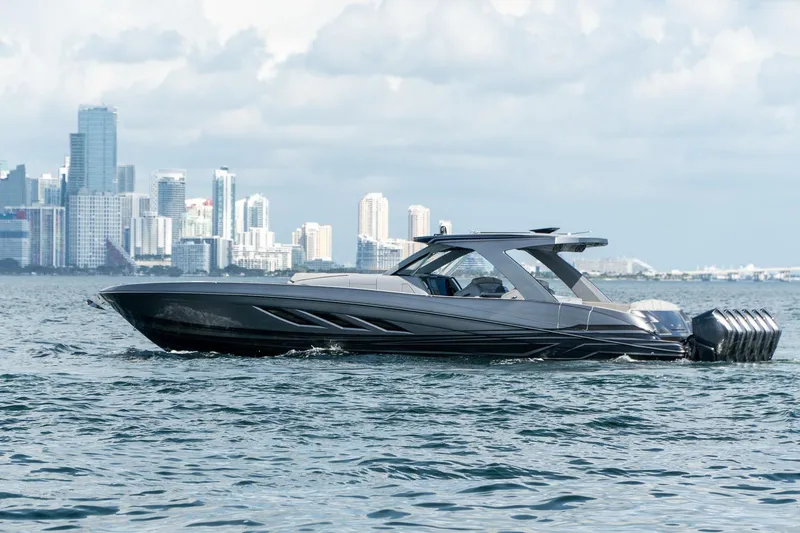  Yacht Photos Pics 2026 Deep Impact 499 Sport boat cruising near city skyline.