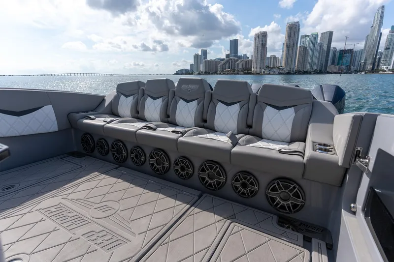  Yacht Photos Pics Luxury seating on 2026 Deep Impact 499 Sport boat with city skyline backdrop.