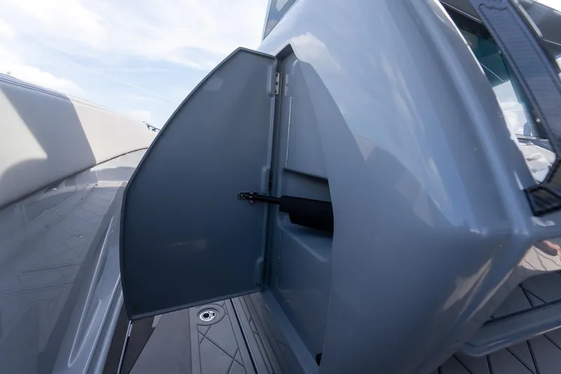  Yacht Photos Pics Open storage compartment on 2026 Deep Impact 499 Sport boat, showcasing sleek design.