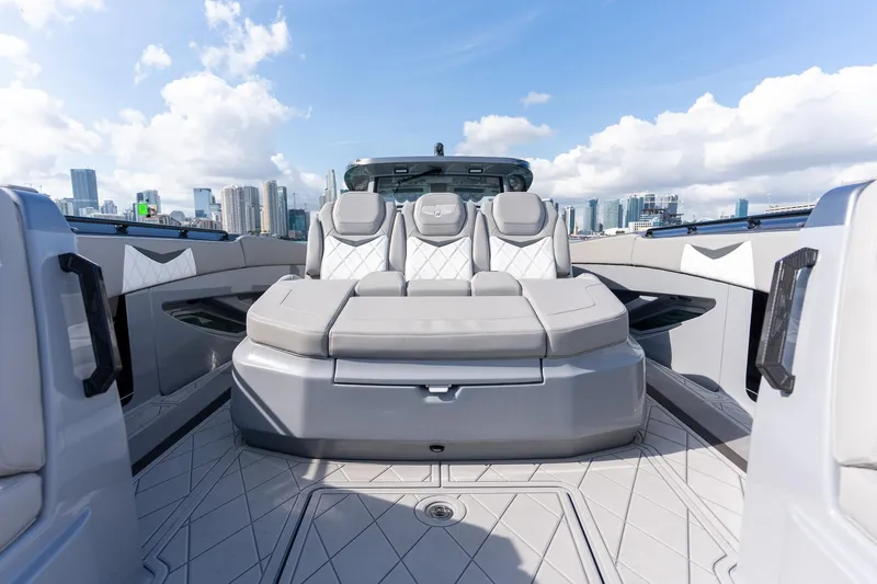  Yacht Photos Pics Luxury seating on 2026 Deep Impact 499 Sport boat with city skyline backdrop.