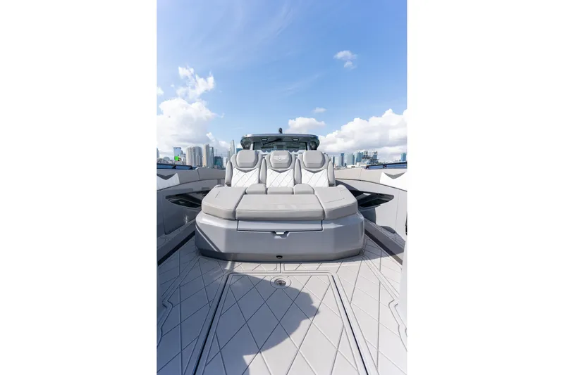  Yacht Photos Pics 2026 Deep Impact 499 Sport luxury boat with sleek seating, city skyline in background.