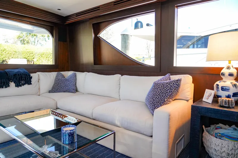 Soteria Yacht Photos Pics Luxurious interior of 1999 Hatteras 70 Convertible yacht with plush seating and elegant decor.