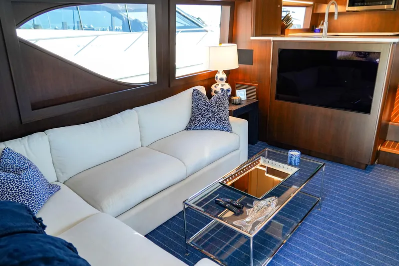 Soteria Yacht Photos Pics Luxurious interior of 1999 Hatteras 70 Convertible yacht with elegant seating and modern decor.