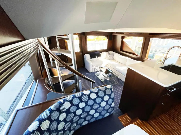 Soteria Yacht Photos Pics Luxurious interior of 1999 Hatteras 70 Convertible yacht with modern furnishings and elegant design.