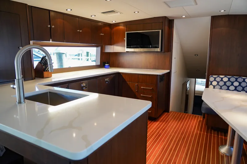 Soteria Yacht Photos Pics Luxurious kitchen interior of 1999 Hatteras 70 Convertible yacht with modern amenities.