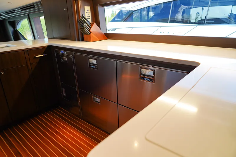 Soteria Yacht Photos Pics Luxurious kitchen interior of 1999 Hatteras 70 Convertible yacht with modern appliances.