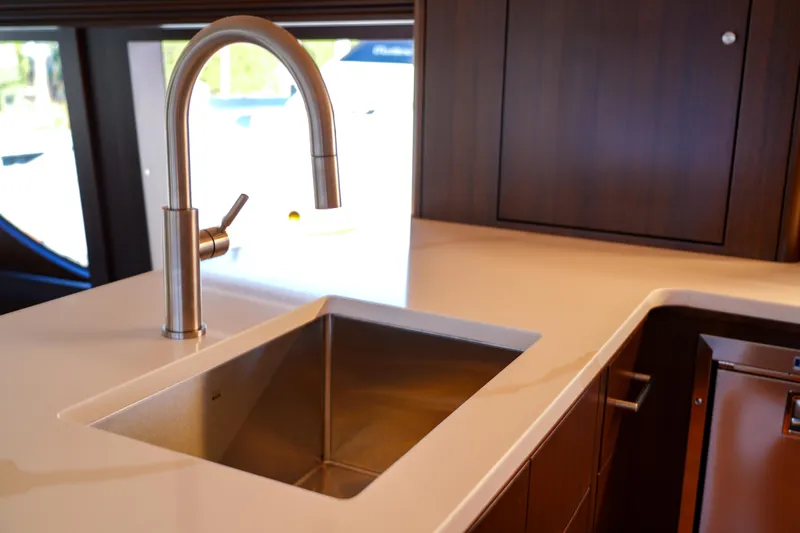 Soteria Yacht Photos Pics Modern kitchen sink on 1999 Hatteras 70 Convertible yacht with sleek faucet design.