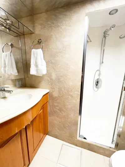 Soteria Yacht Photos Pics Luxurious bathroom in 1999 Hatteras 70 Convertible yacht with shower and vanity.