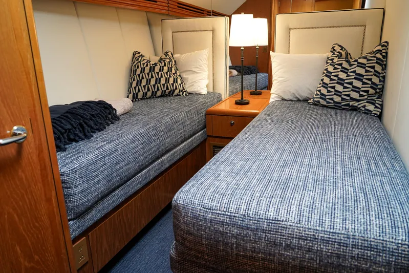 Soteria Yacht Photos Pics Cozy twin cabin interior on 1999 Hatteras 70 Convertible yacht with stylish bedding.