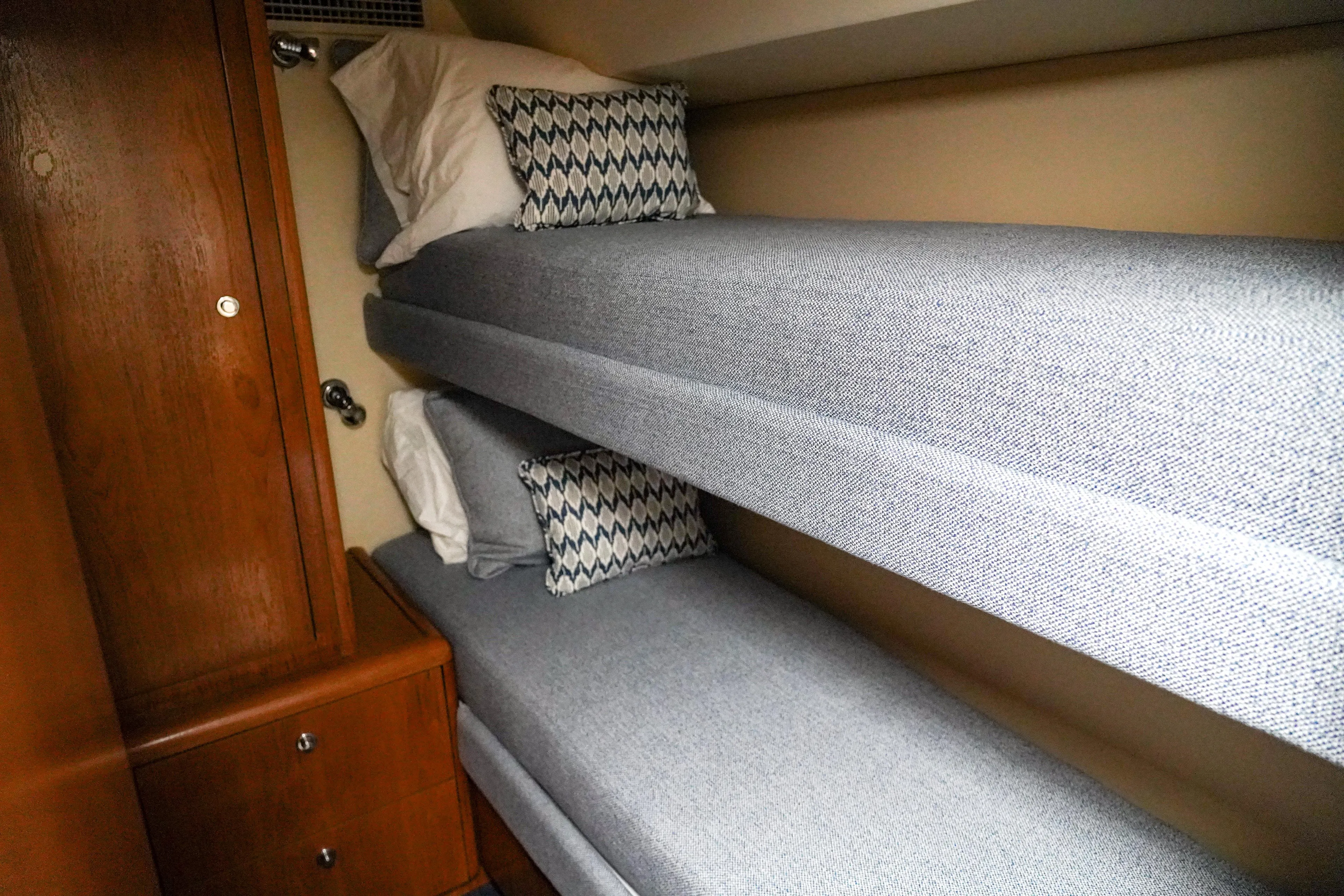 Soteria Yacht Photos Pics Bunk beds in 1999 Hatteras 70 Convertible yacht cabin with wooden cabinet.