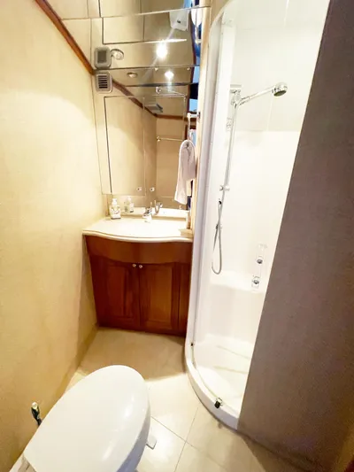Soteria Yacht Photos Pics Bathroom interior of 1999 Hatteras 70 Convertible yacht with shower and vanity.