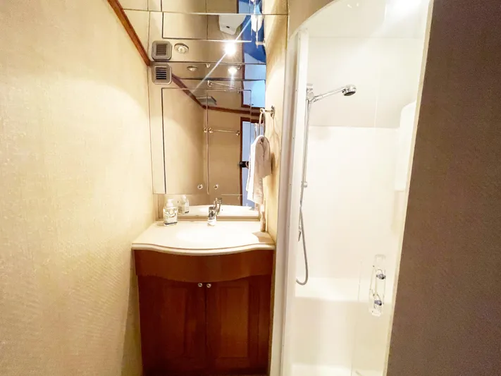 Soteria Yacht Photos Pics Bathroom interior of 1999 Hatteras 70 Convertible yacht with shower and vanity.