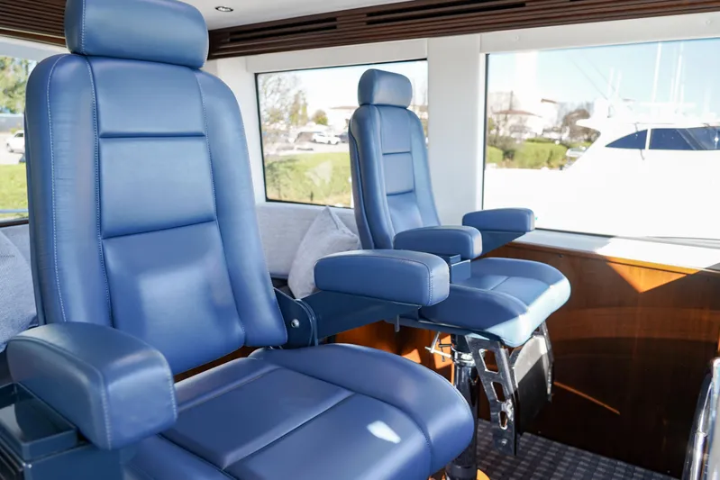 Soteria Yacht Photos Pics Luxurious blue captain chairs inside 1999 Hatteras 70 Convertible yacht.