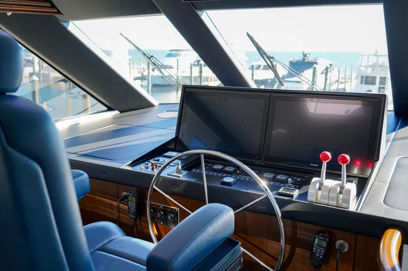 Soteria Yacht Photos Pics Helm of 1999 Hatteras 70 Convertible yacht with dual screens and controls.