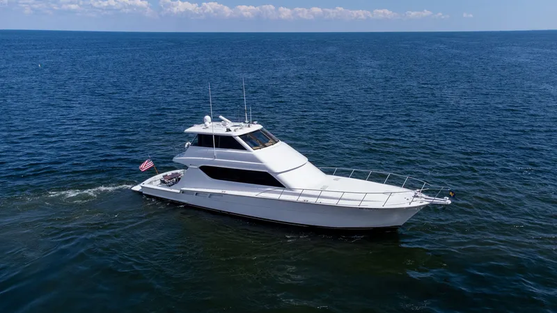 Soteria Yacht Photos Pics 1999 Hatteras 70 Convertible yacht cruising on open sea under clear skies.