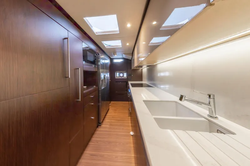Cecilou Yacht Photos Pics Luxurious kitchen interior of 2018 Sanlorenzo Cayman Yachts F920 with modern design and wood finishes.