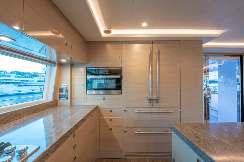 Homarus Yacht Photos Pics Luxurious yacht kitchen interior with modern appliances and sleek wooden cabinetry, Horizon 2021.