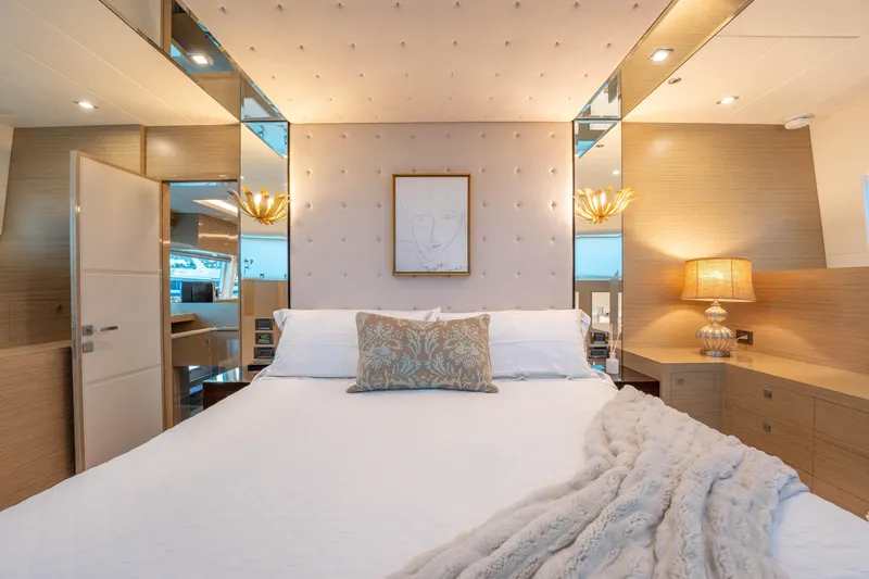Homarus Yacht Photos Pics Luxurious yacht bedroom with elegant decor, plush bedding, and ambient lighting, Horizon 2021 model.