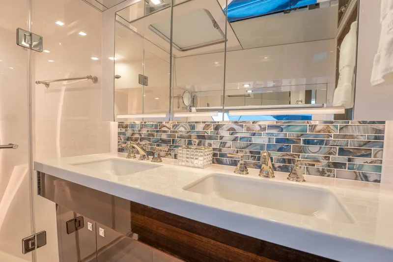 Homarus Yacht Photos Pics Luxurious 2021 Horizon bathroom with dual sinks, elegant fixtures, and stylish mosaic backsplash.