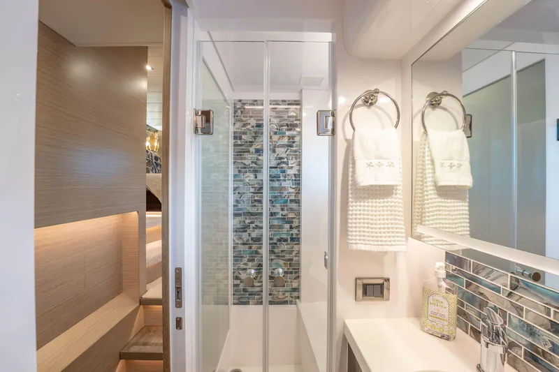 Homarus Yacht Photos Pics Modern yacht bathroom with glass shower, elegant tiles, and luxury amenities, Horizon 2021.