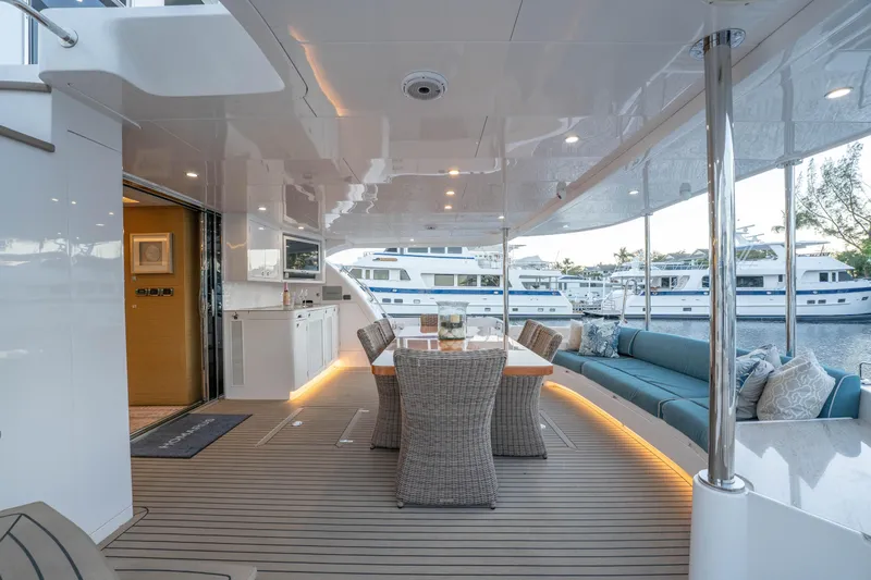 Homarus Yacht Photos Pics Luxurious Horizon yacht deck with dining area and seating, docked at marina, 2021 model.