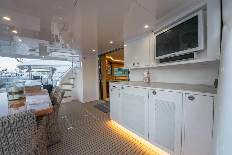 Homarus Yacht Photos Pics Luxurious Horizon yacht deck with dining area, TV, and elegant cabinetry, 2021 model.