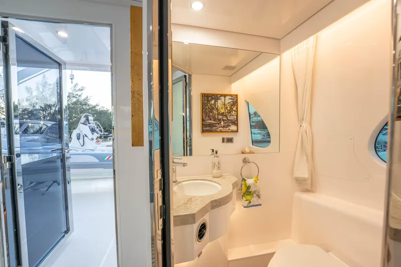 Homarus Yacht Photos Pics Luxurious yacht bathroom with modern fixtures, large mirror, and scenic window view, Horizon 2021.