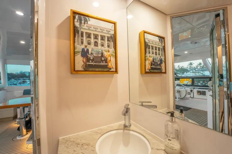 Homarus Yacht Photos Pics Luxurious yacht bathroom with framed photo, modern sink, and view of the helm. Horizon 2021.