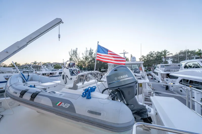Homarus Yacht Photos Pics Inflatable boat with Yamaha motor and American flag, docked at marina, Horizon 2021.