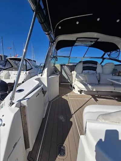 2 Spicy Yacht Photos Pics 2003 Sea Ray 380 Sundancer yacht interior with seating, under a clear blue sky.