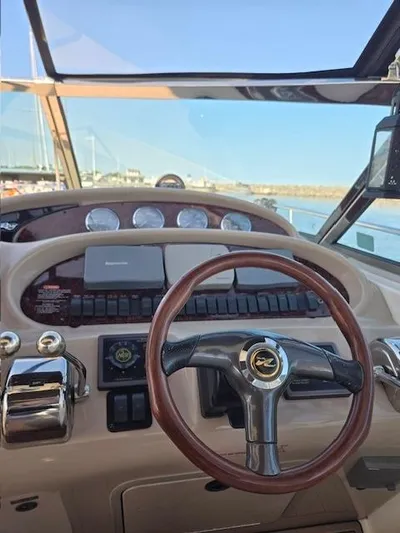 2 Spicy Yacht Photos Pics Helm of 2003 Sea Ray 380 Sundancer with wooden steering wheel and gauges.