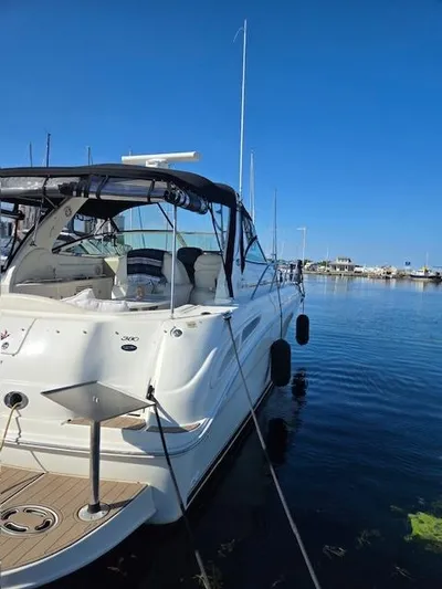 2 Spicy Yacht Photos Pics 2003 Sea Ray 380 Sundancer yacht docked in a marina under clear blue skies.