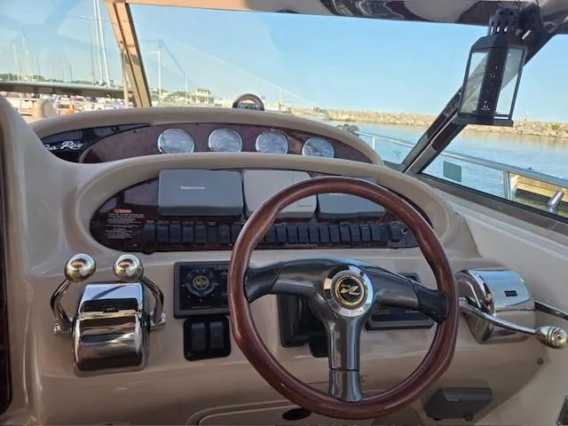 2 Spicy Yacht Photos Pics Helm of 2003 Sea Ray 380 Sundancer with steering wheel and controls, docked at marina.