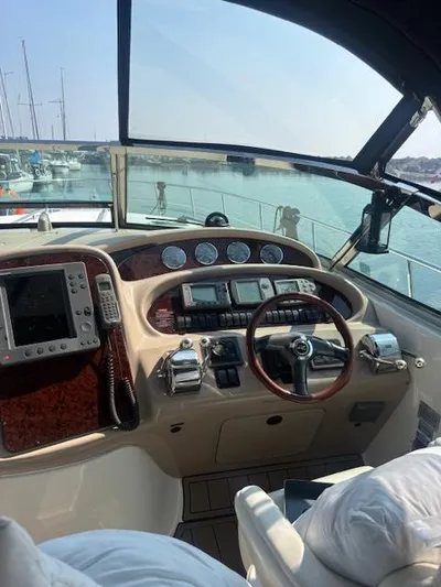 2 Spicy Yacht Photos Pics Helm of 2003 Sea Ray 380 Sundancer yacht with navigation instruments and steering wheel.