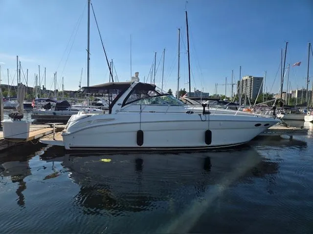 2 Spicy Yacht Photos Pics 2003 Sea Ray 380 Sundancer yacht docked in a marina under clear blue skies.