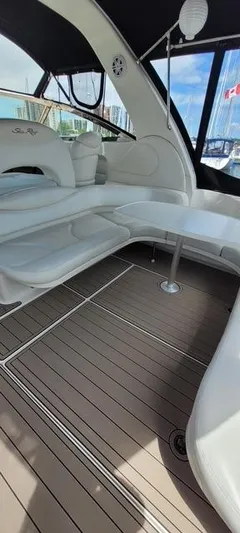 2 Spicy Yacht Photos Pics Interior of 2003 Sea Ray 380 Sundancer yacht with white seating and wooden flooring.