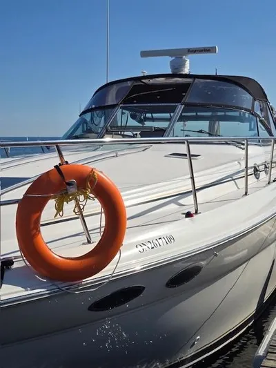 2 Spicy Yacht Photos Pics 2003 Sea Ray 380 Sundancer yacht with lifebuoy, docked under clear blue sky.