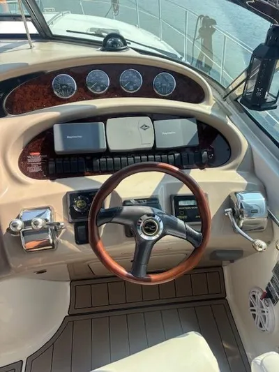 2 Spicy Yacht Photos Pics Helm of 2003 Sea Ray 380 Sundancer with wood-accented steering wheel and instrument panel.