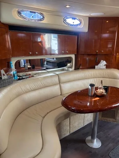 2 Spicy Yacht Photos Pics Luxurious interior of 2003 Sea Ray 380 Sundancer with leather seating and wooden table.