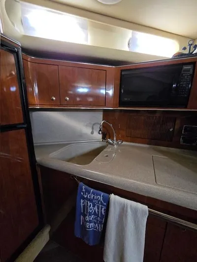 2 Spicy Yacht Photos Pics 2003 Sea Ray 380 Sundancer kitchen with wood cabinets and modern appliances.