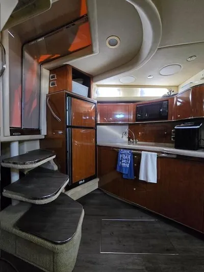 2 Spicy Yacht Photos Pics Interior of 2003 Sea Ray 380 Sundancer yacht with modern kitchen and wooden cabinetry.