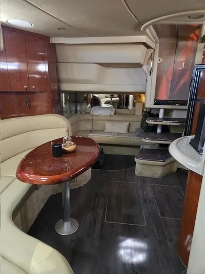 2 Spicy Yacht Photos Pics Luxurious interior of a 2003 Sea Ray 380 Sundancer yacht with elegant seating and wood finishes.