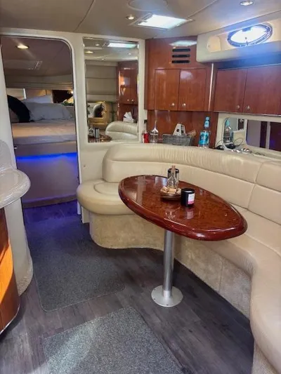 2 Spicy Yacht Photos Pics Interior of 2003 Sea Ray 380 Sundancer yacht with elegant seating and wooden table.